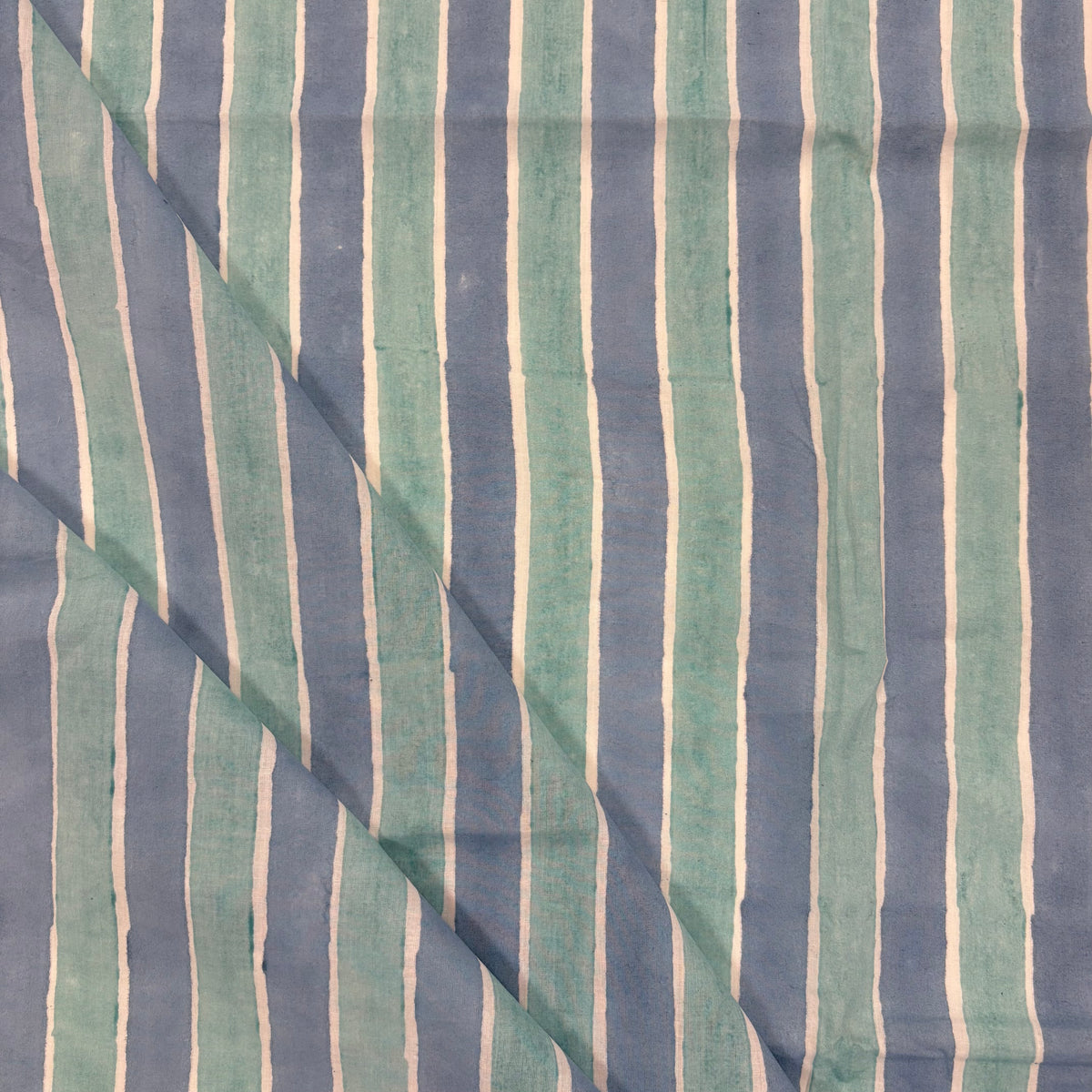 Blue Ocean Stripe Indian Print Cotton Fabric, folded, lightweight soft cotton with a traditional handcrafted Indian tartan check pattern.