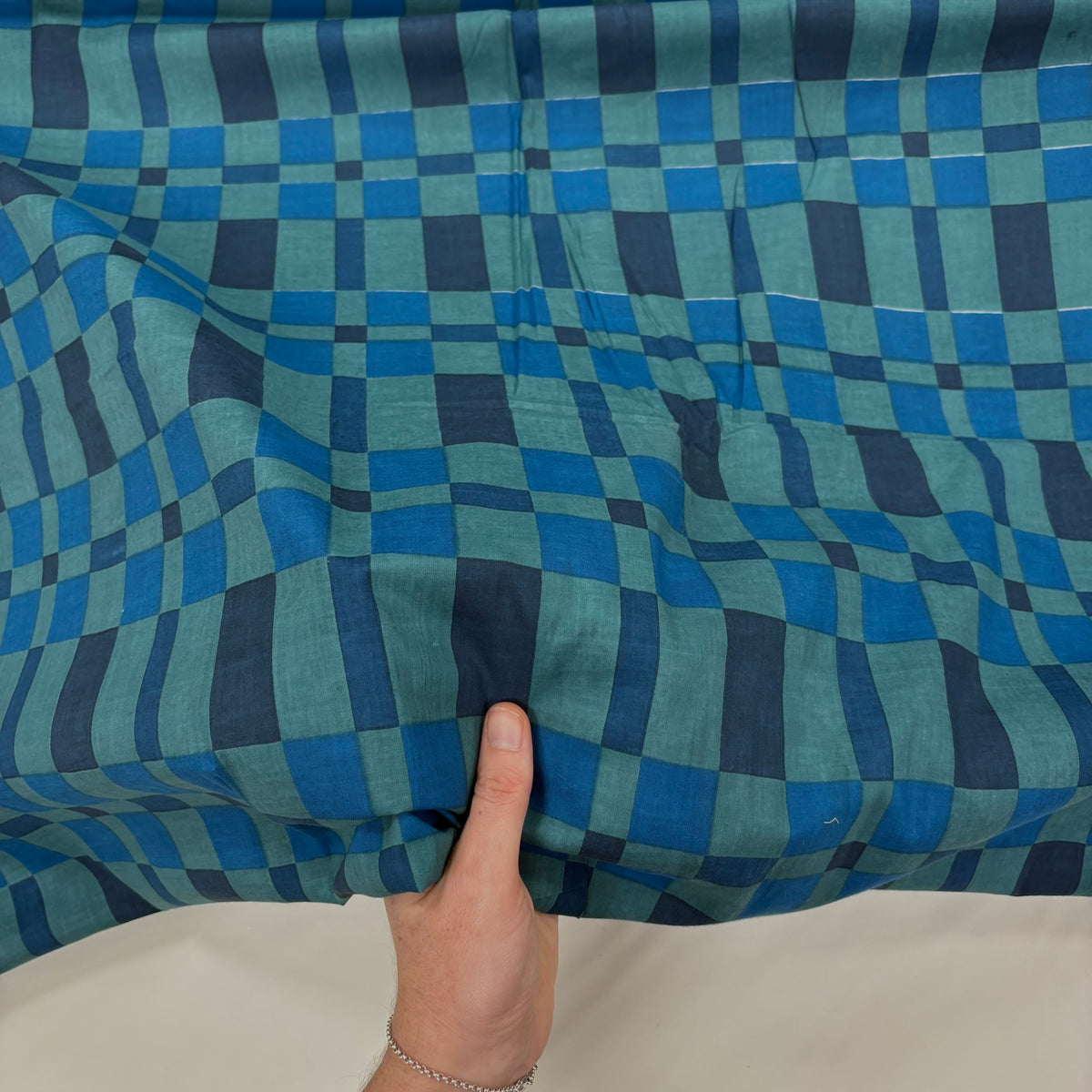 Blue blanket Check Indian Block Print Cotton Fabric with hand for scale, lightweight 100gsm printed cotton for dressmaking, handmade gifts, crafts and soft furnishings, handcrafted using traditional Indian printing techniques.