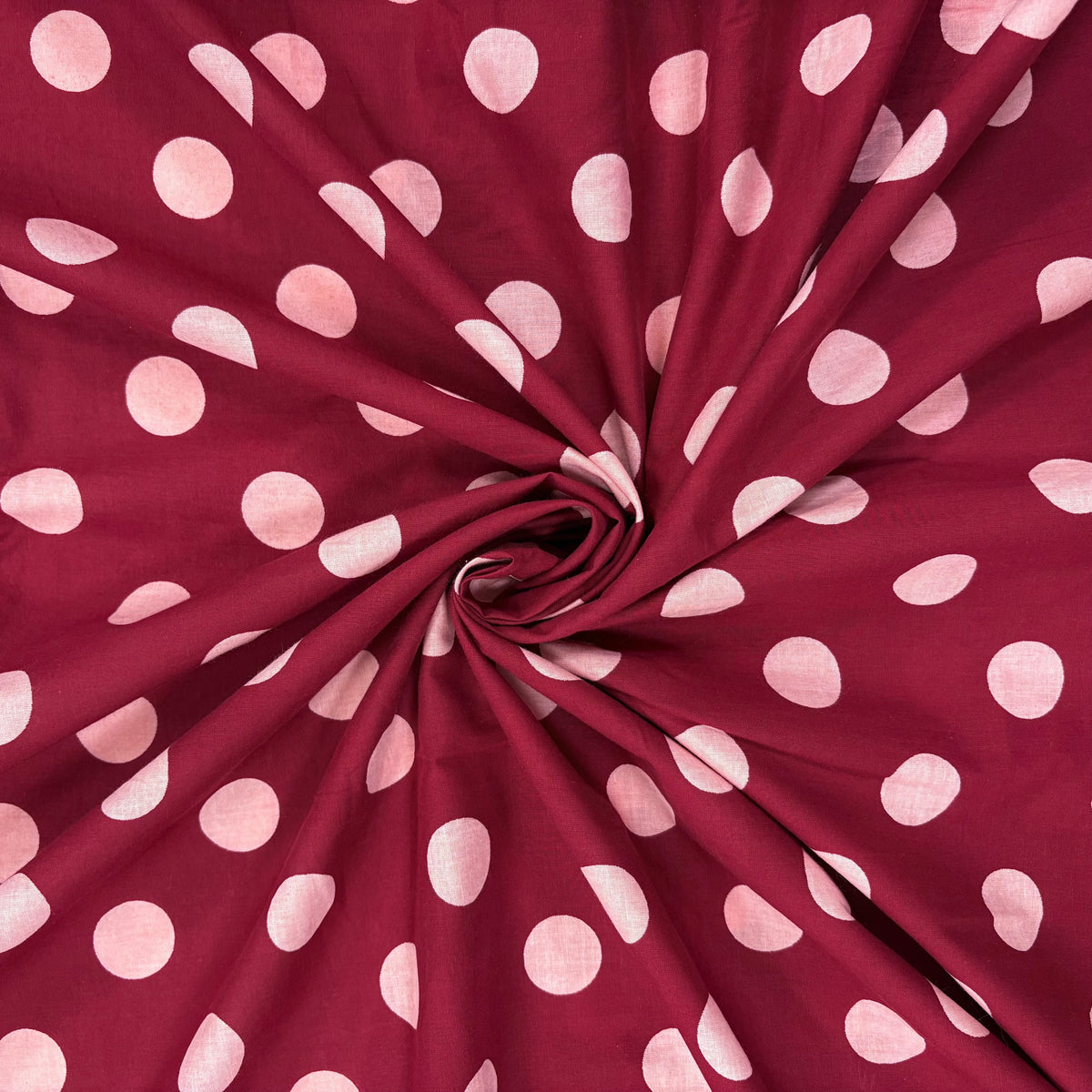 Burgundy Spotty Indian Print Cotton Fabric, gathered. Lightweight 100gsm printed cotton for dressmaking, handmade gifts, crafts and soft furnishings, handcrafted using traditional Indian printing techniques.