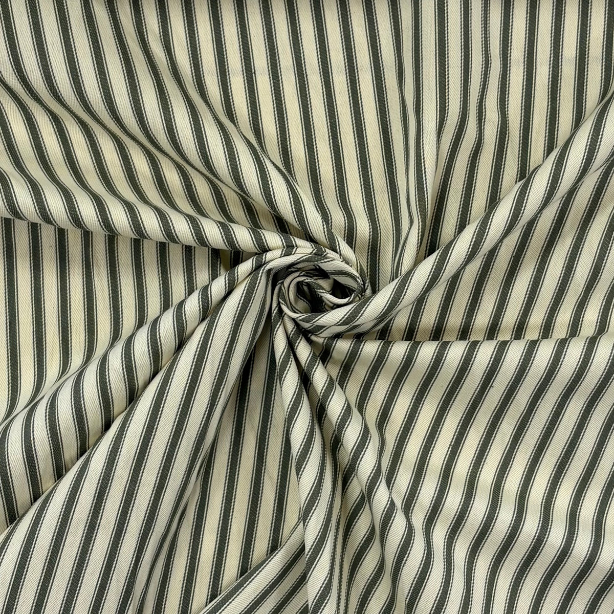 Classic forest green cotton ticking fabric with traditional stripes twisted to show drape, ideal for cushions, tablecloths, table runners, lampshades, home furnishings and DIY craft projects. Timeless striped cotton fabric for contemporary and country style interiors.
