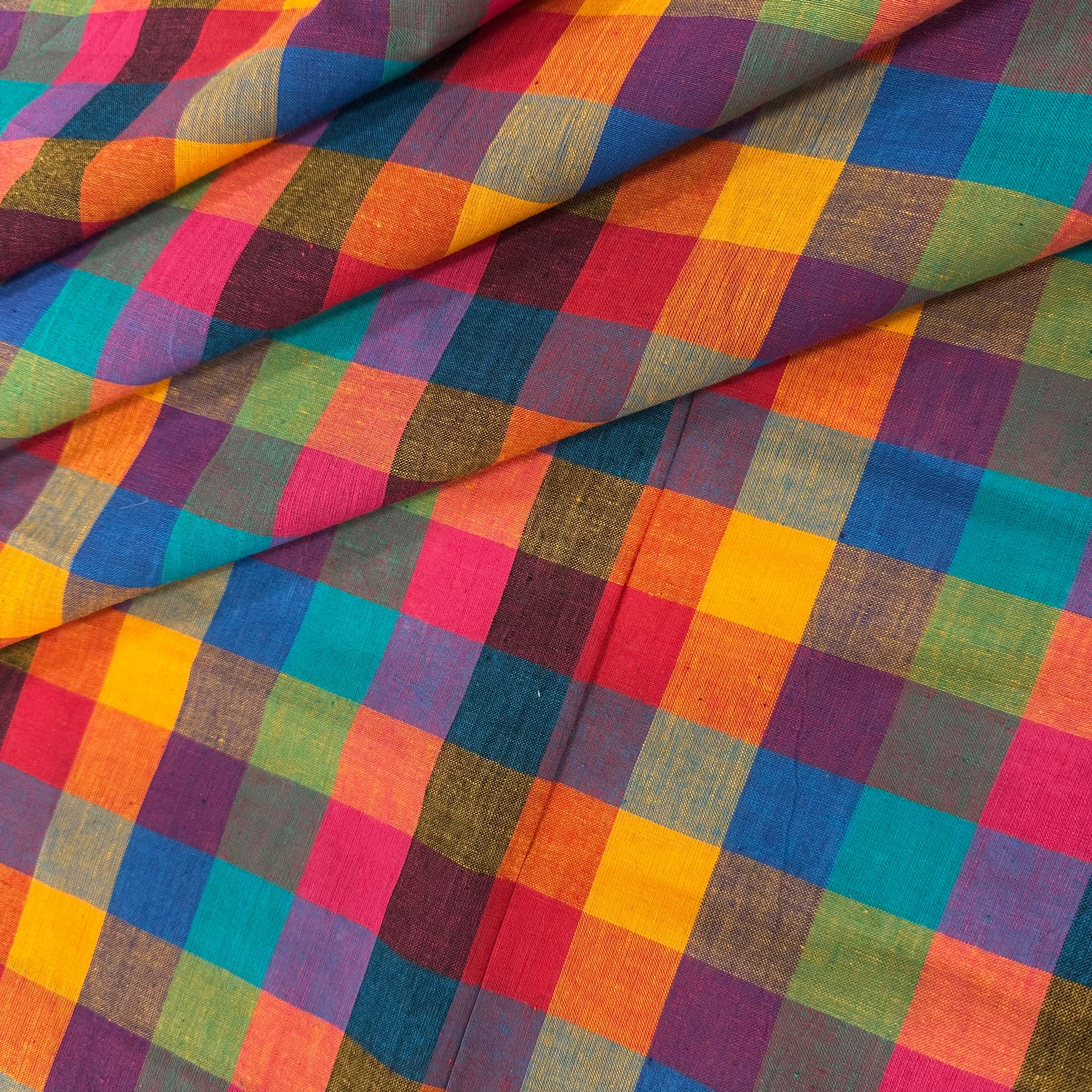 Multicolored checkered fabric with a pattern of squares in various colors.
