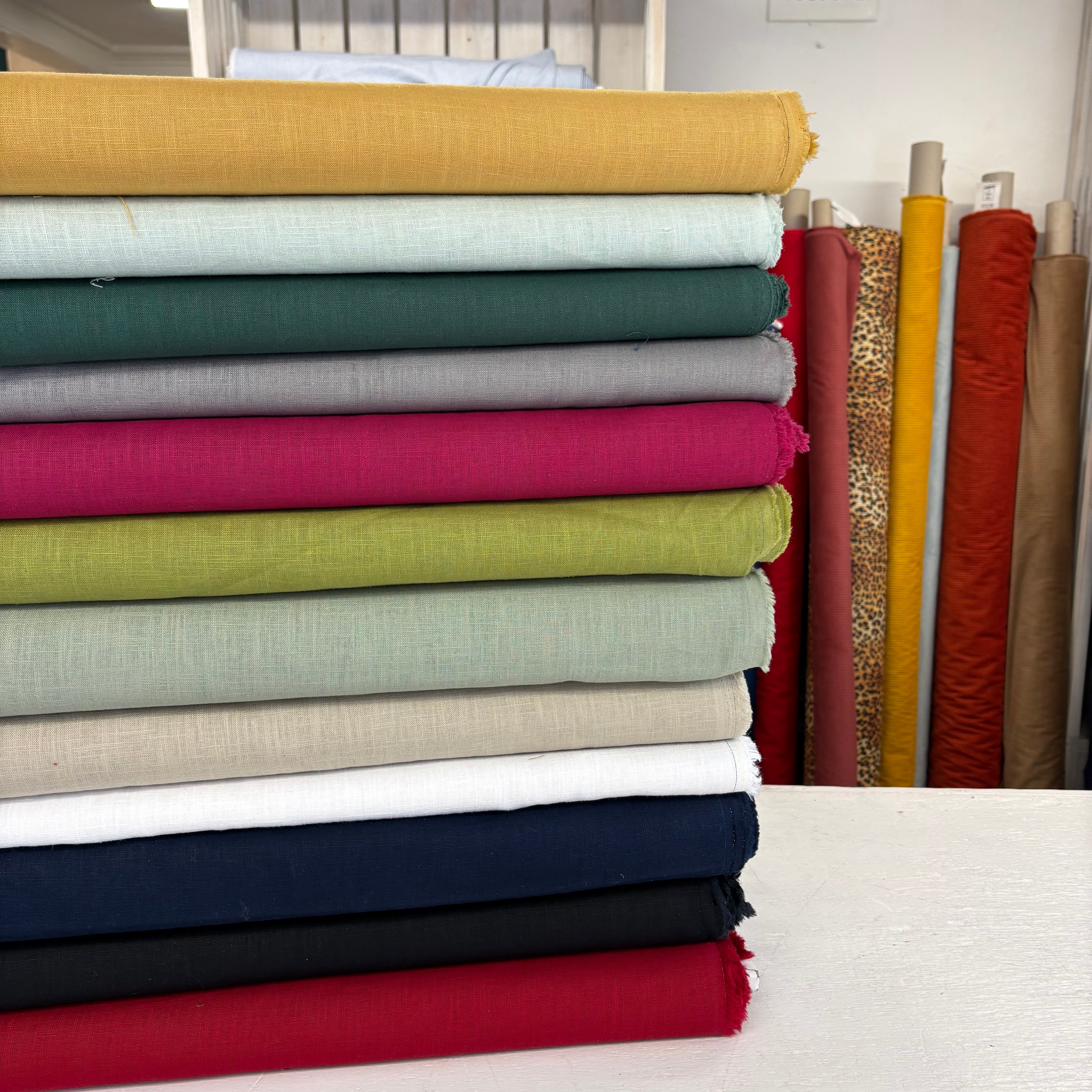 stack of fabrics showing full colour range of ramie fabric