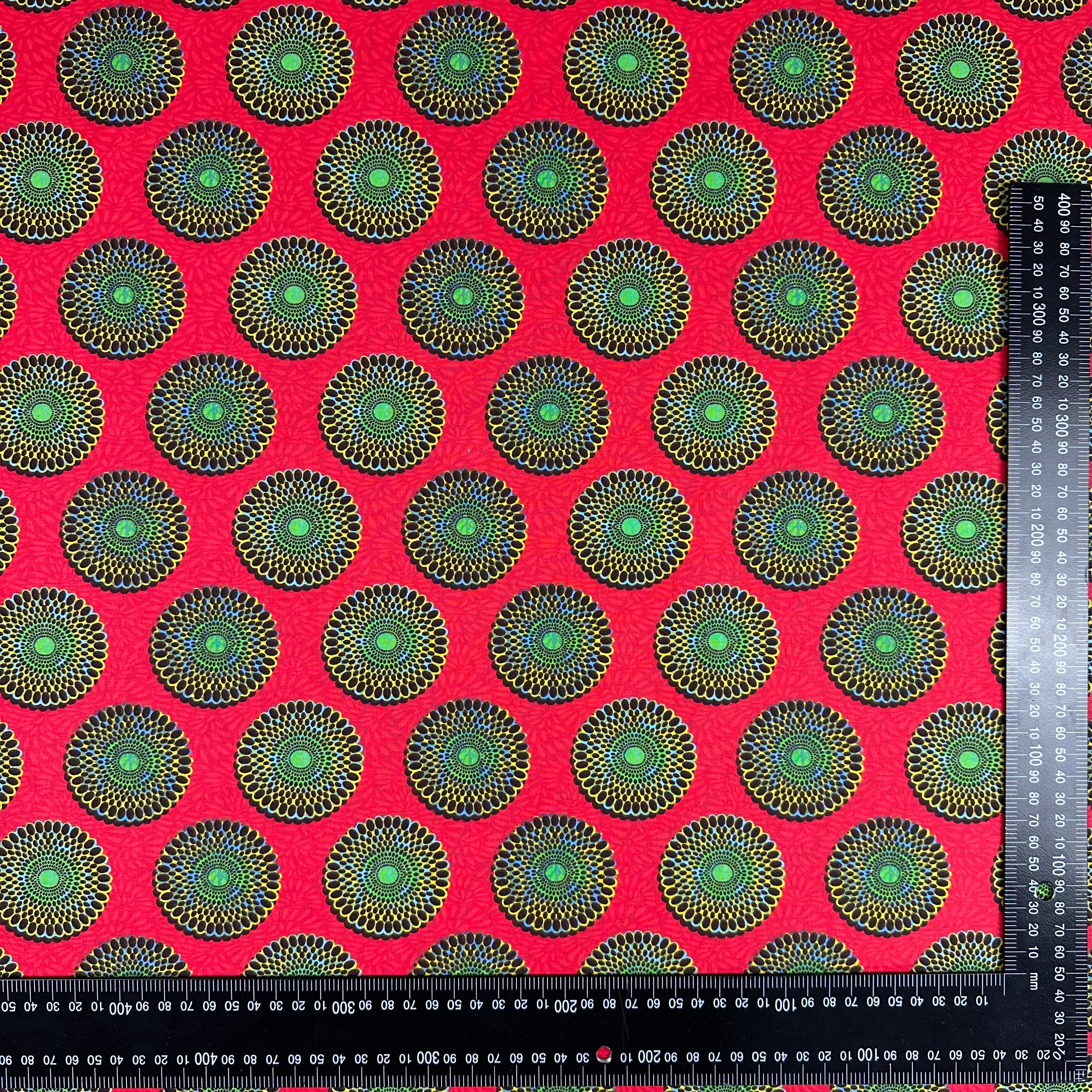 H427 Sunburst Cotton Red fabric with ruler for scale