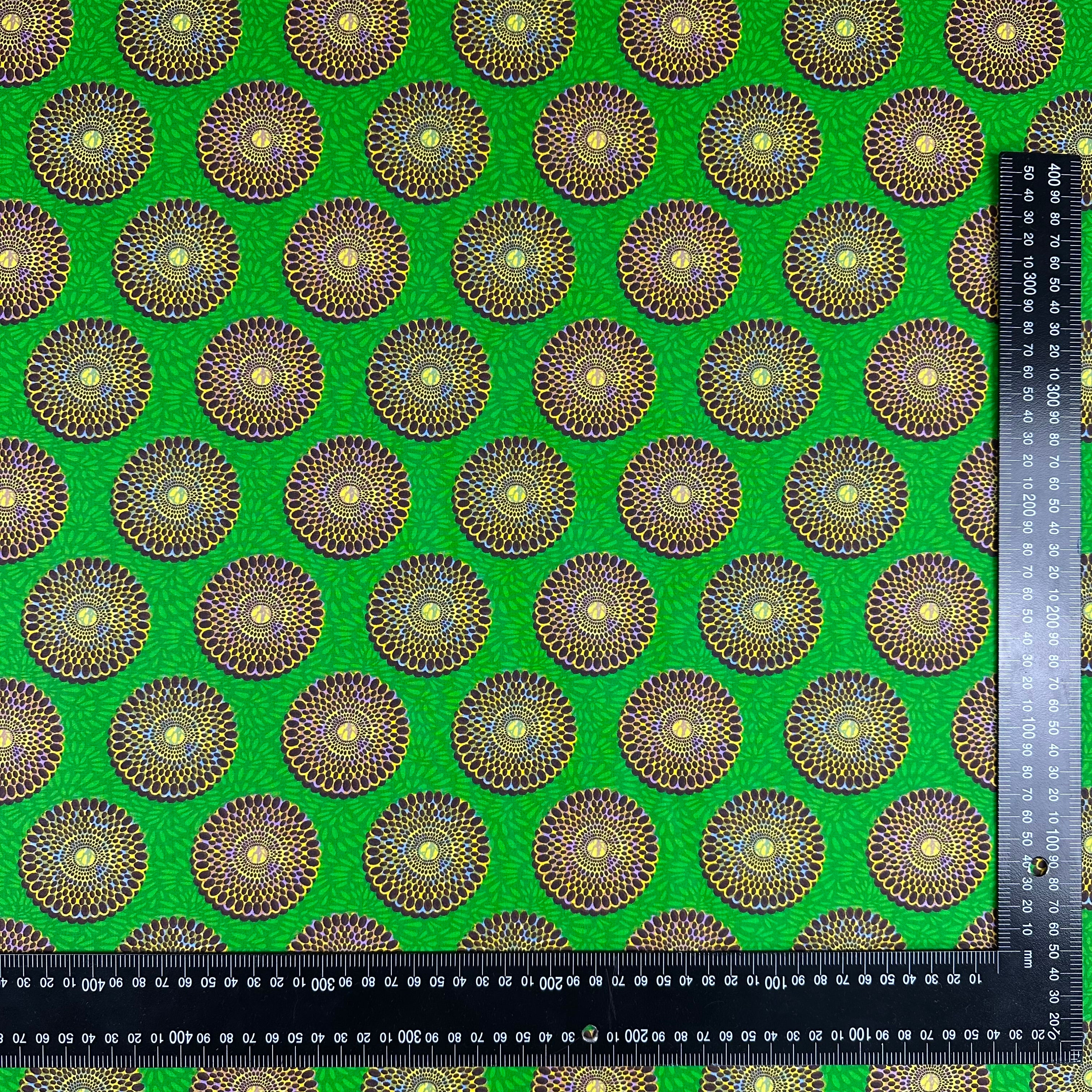 H428 Sunburst Cotton Green fabric with ruler for scale