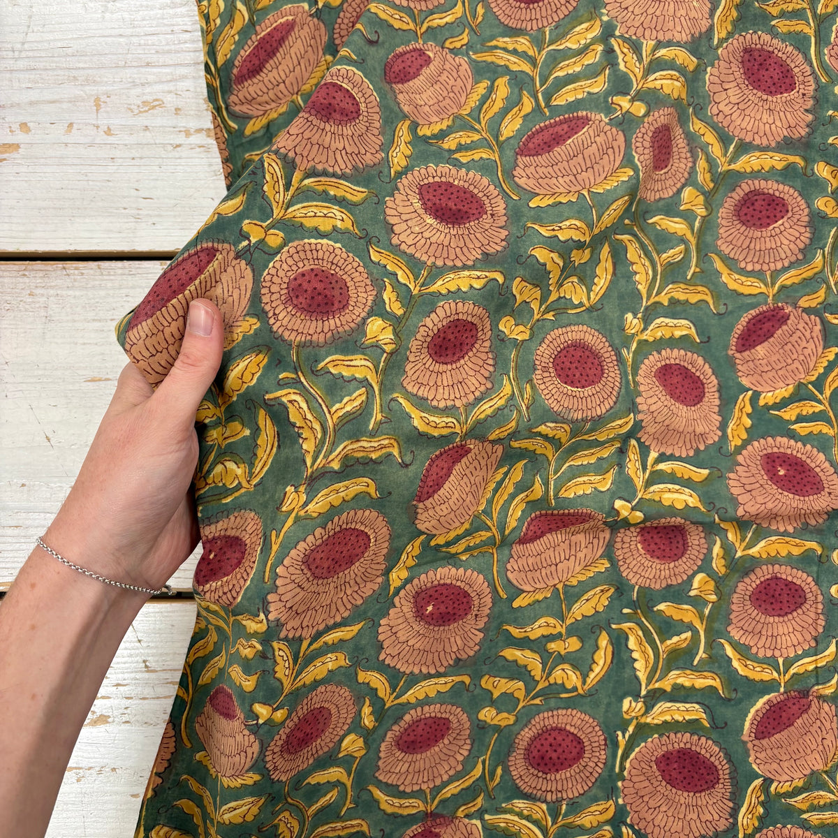 Marigold Floral Block Print Cotton Fabric, with hand for scale, lightweight soft cotton with a traditional handcrafted Indian floral pattern