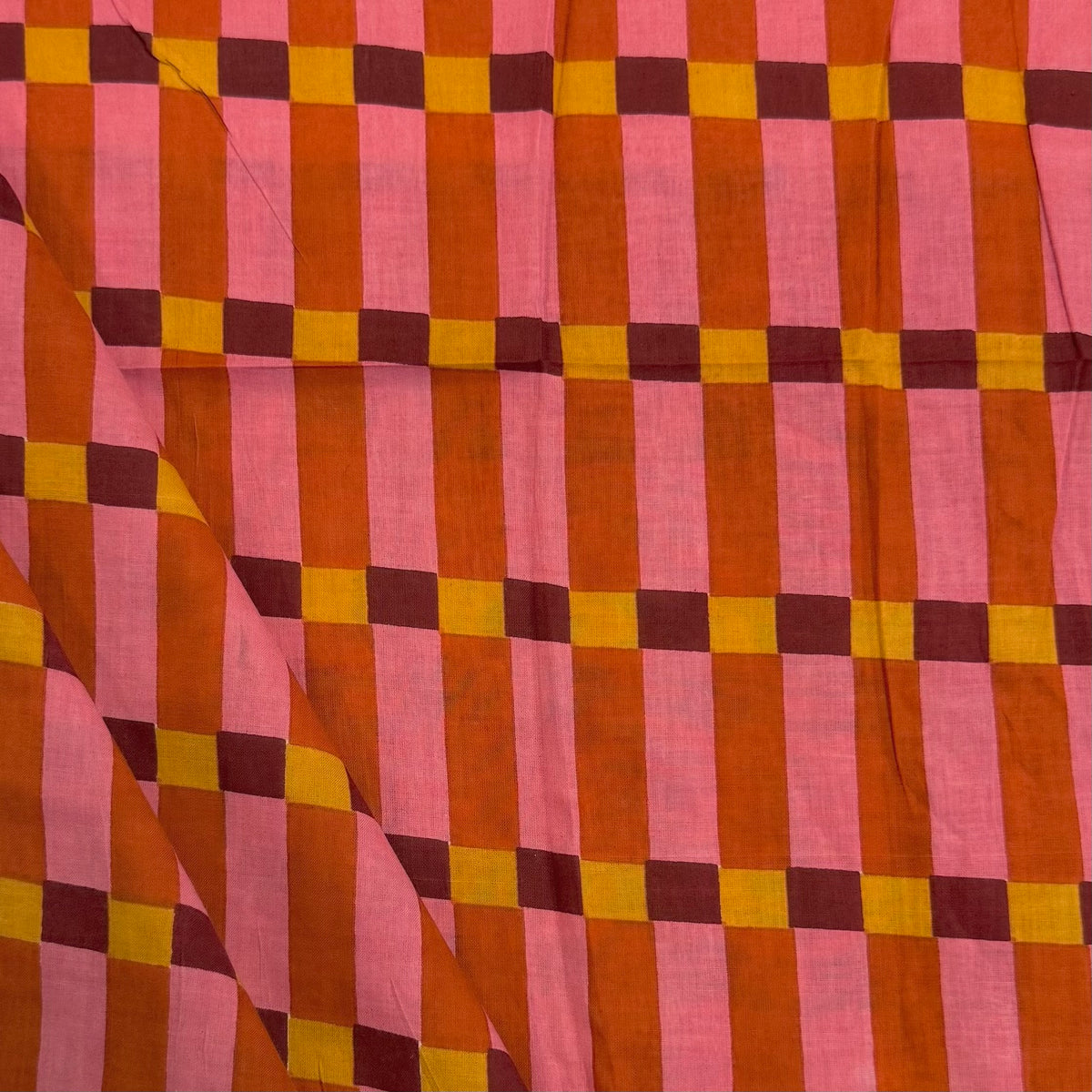 Pink Humbug Check Indian Block Print Cotton Fabric folded, lightweight 100gsm printed cotton for dressmaking, handmade gifts, crafts and soft furnishings, handcrafted using traditional Indian printing techniques.