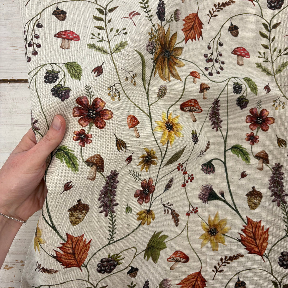 Prestigious Acorn Autumn Fabric With Hand For Scale