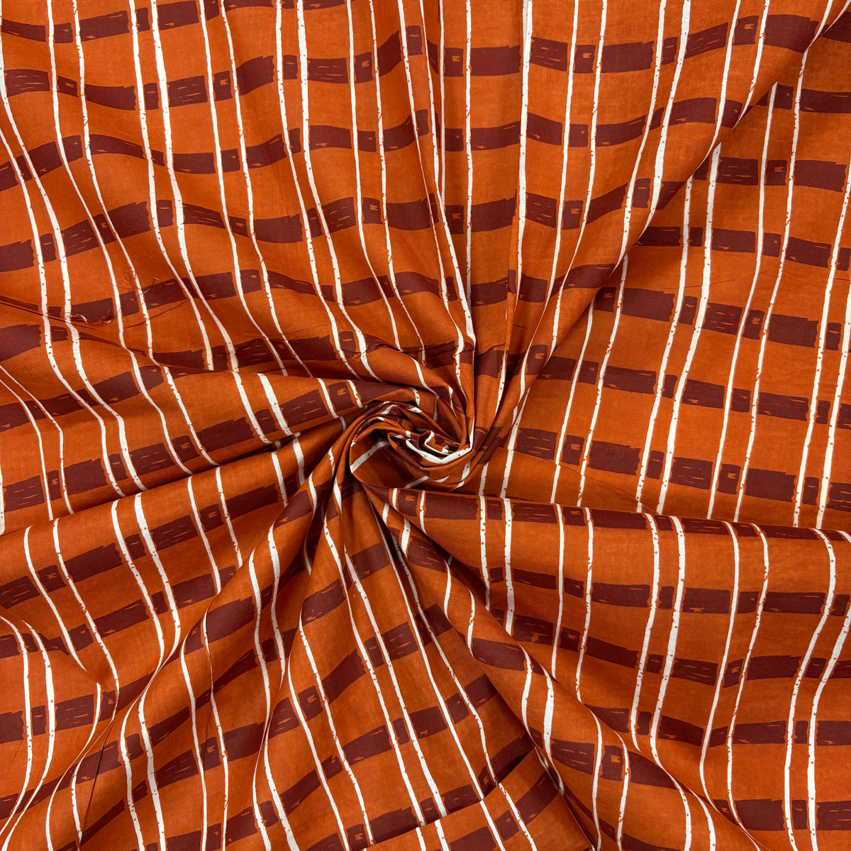 Rust Sketch Tartan Block Print Cotton Fabric, gathered, lightweight soft cotton with a traditional handcrafted Indian tartan check pattern.