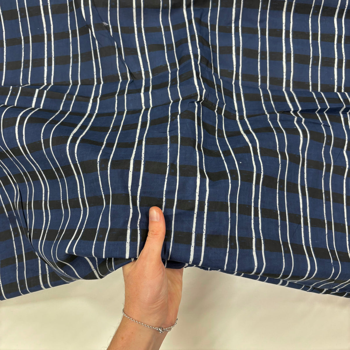 Sketch Tartan Block Print Cotton Fabric, with hand for scale, lightweight soft cotton with a traditional handcrafted Indian tartan check pattern.