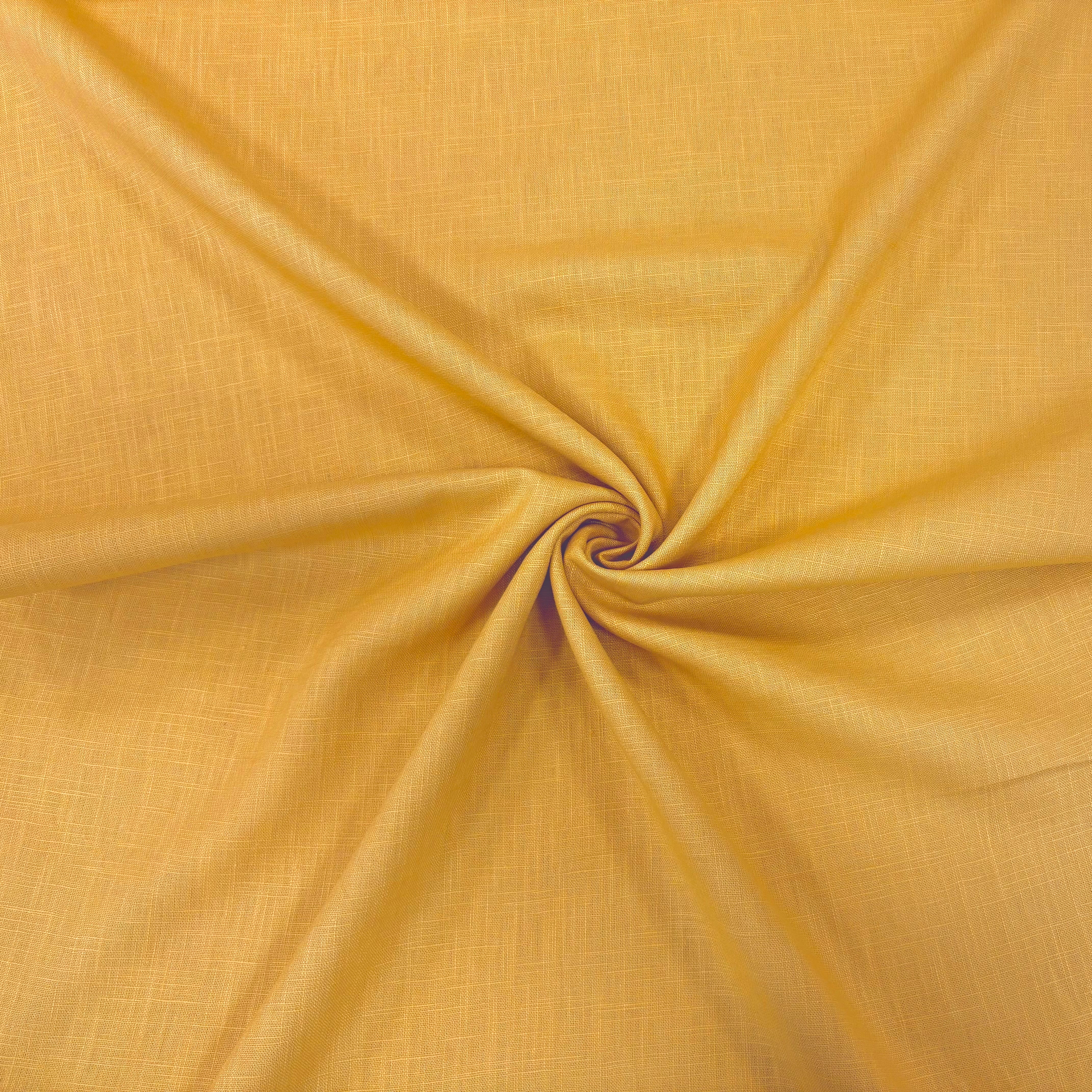 Twisted image of mustard ramie linen fabric showing its natural weave and textured surface.