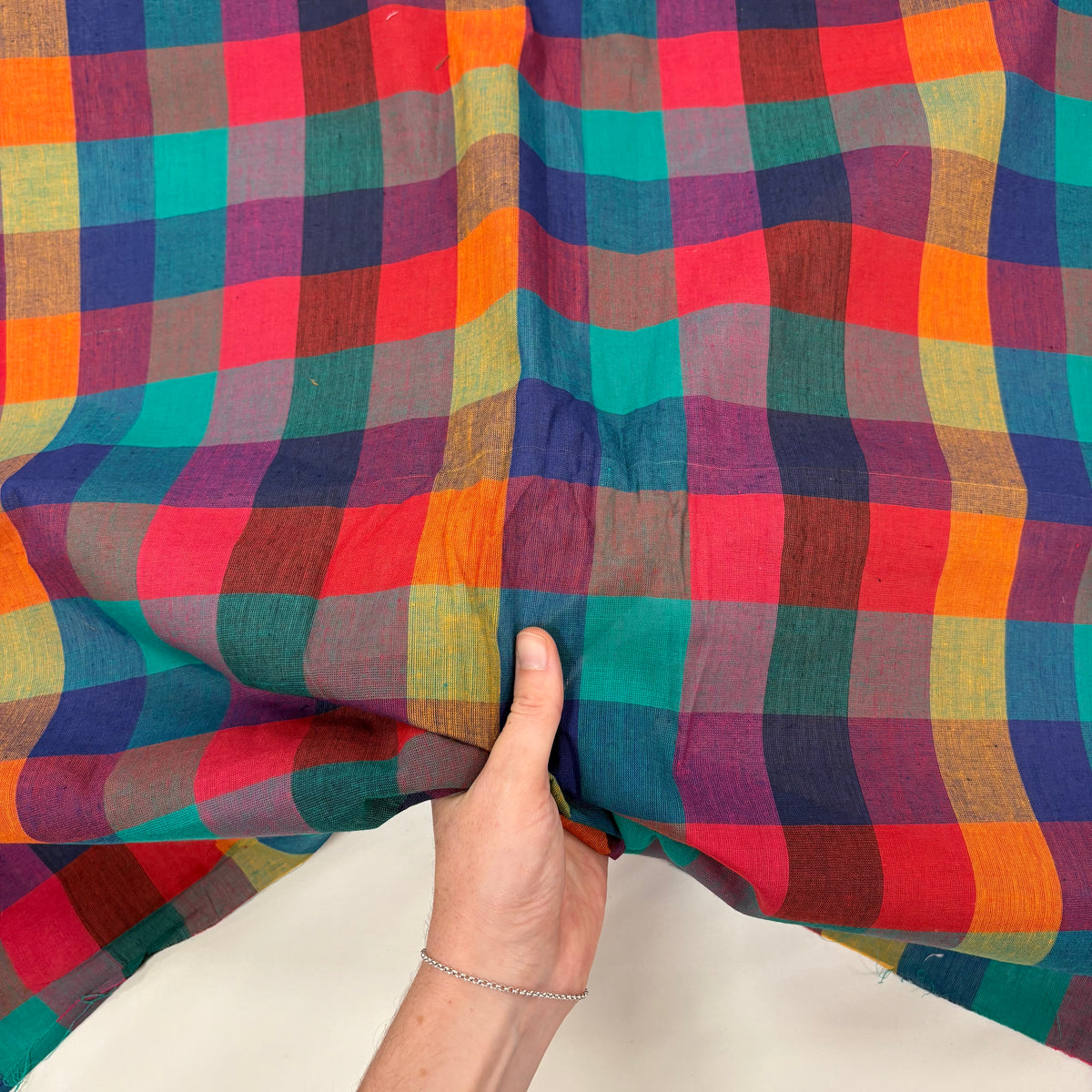 Woven Rainbow Block Gingham Tex Ex 2975 Fabric with hand for scale