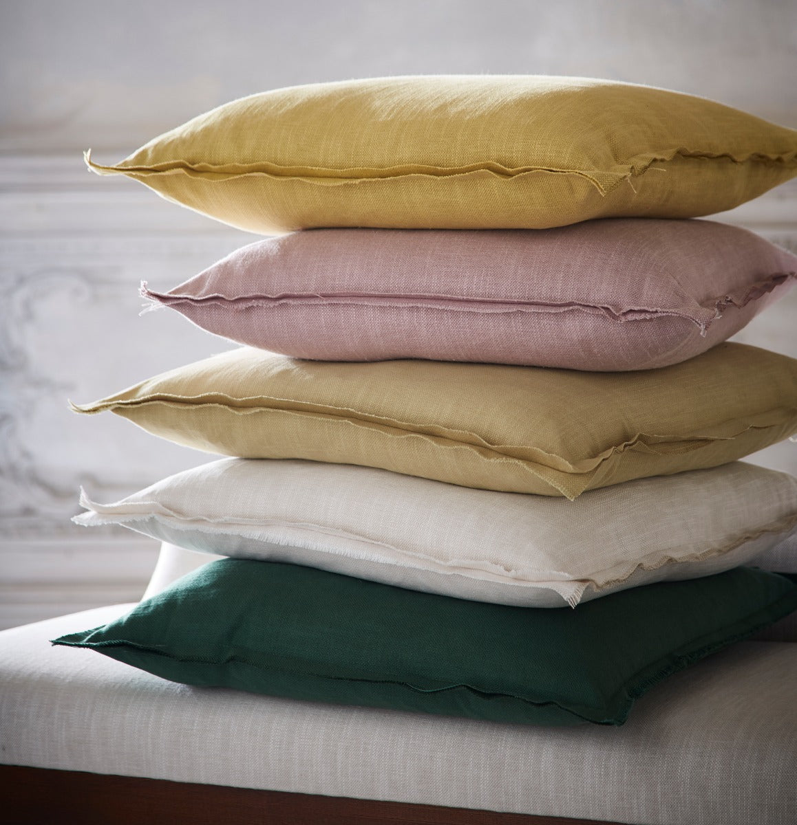 Stack of colorful pillows on a bed