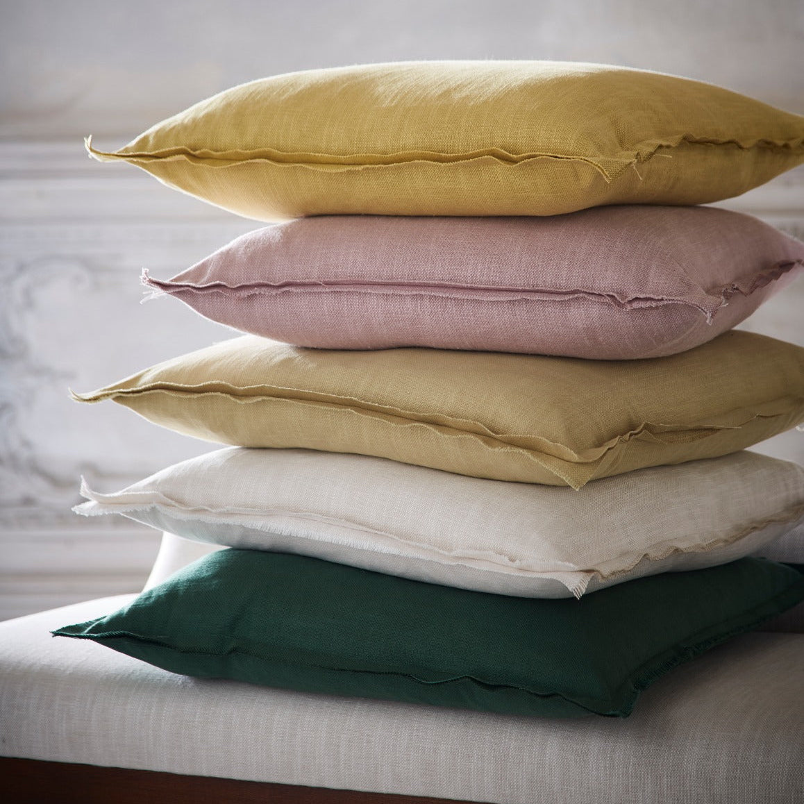 Stack of colorful pillows on a bed