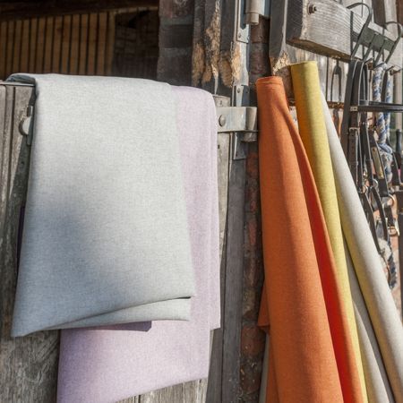 Colorful fabric samples hanging on a wooden wall