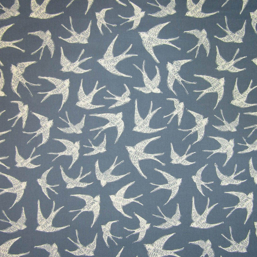 Cotton curtain fabric with coastal bird print on navy blue background.