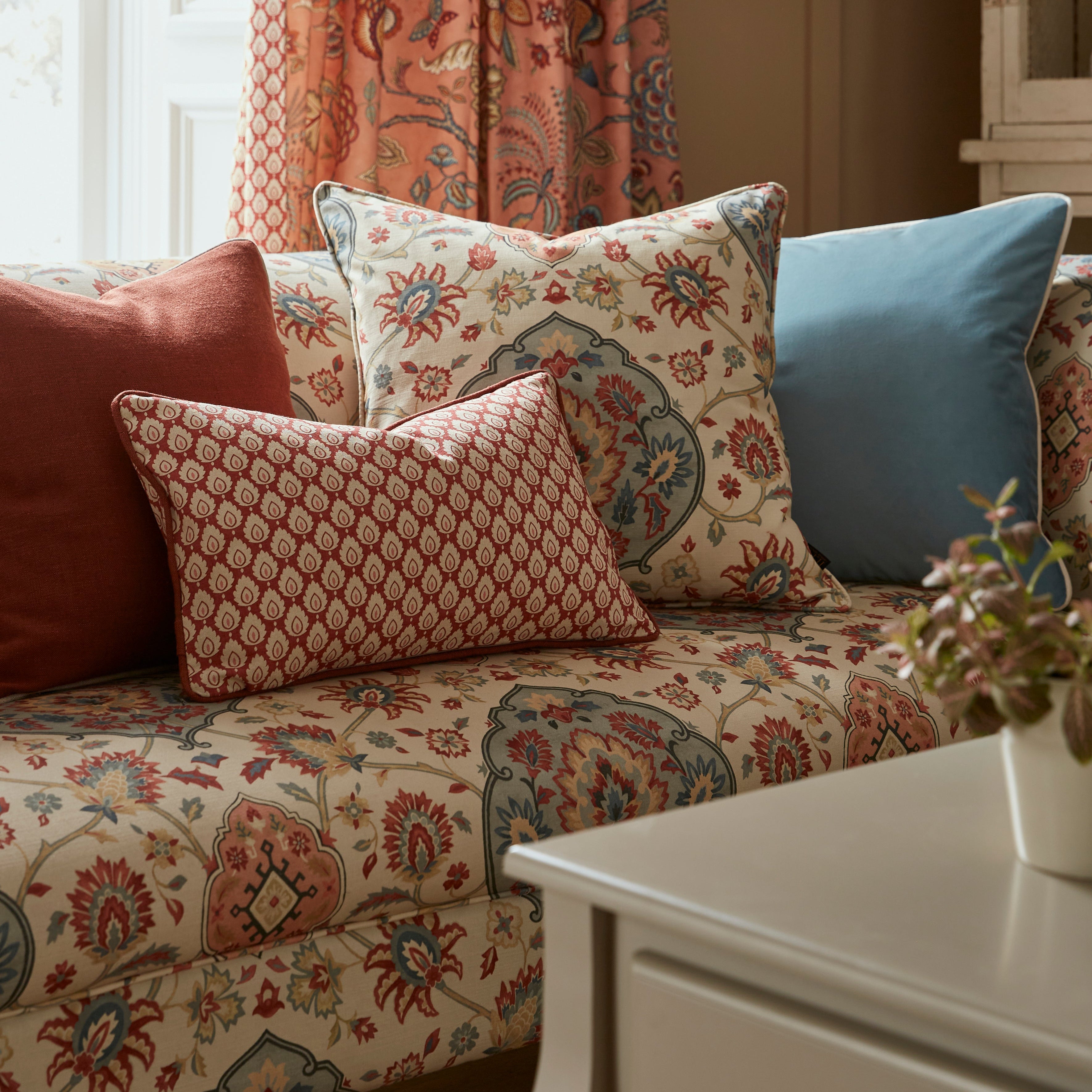 Patterned sofa with colorful cushions in a living room setting