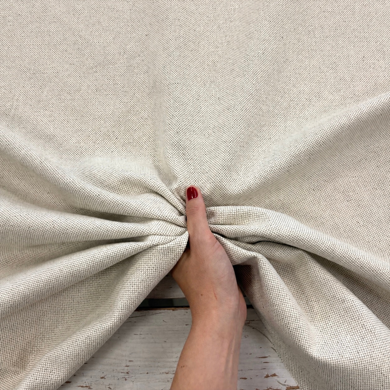 Linen upholstery fabric with texture being ruched to show texture and structure 