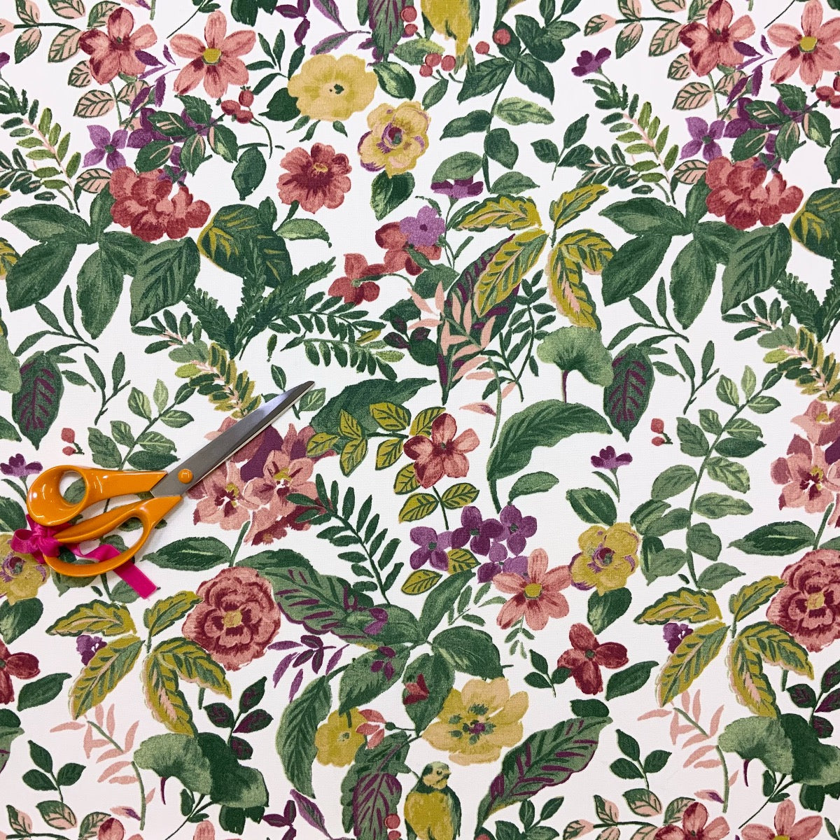 Clarke & Clarke floral cotton curtain fabric with leaves and birds. Scissors for scale. 