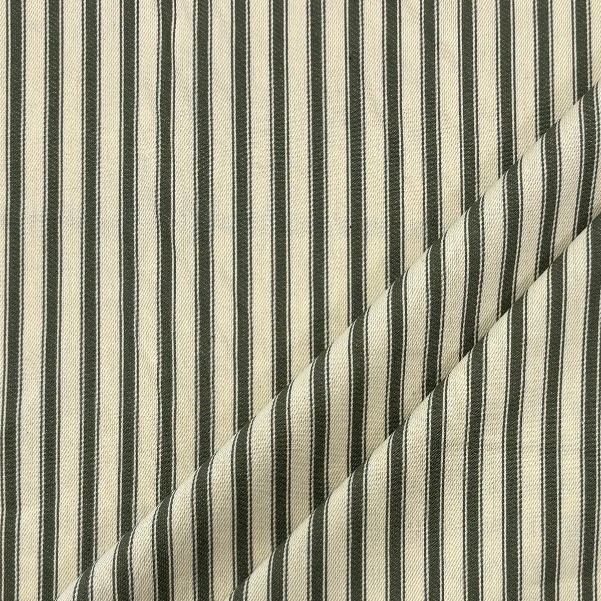Classic forest green cotton ticking fabric with traditional stripes folded at corner, ideal for cushions, tablecloths, table runners, lampshades, home furnishings and DIY craft projects. 