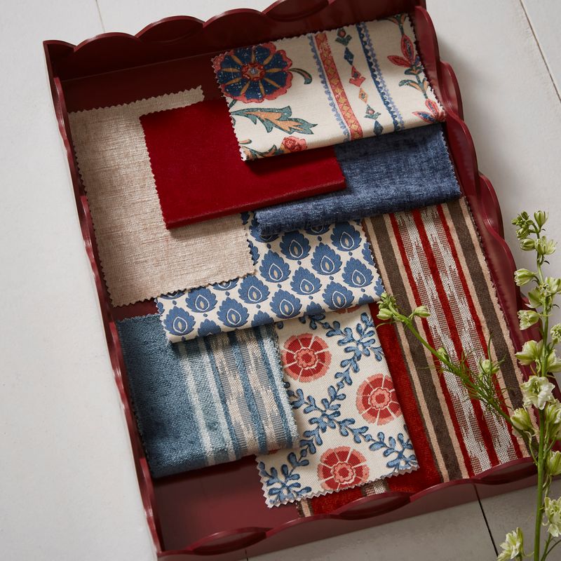 Collection of fabric swatches in a decorative tray on a light background
