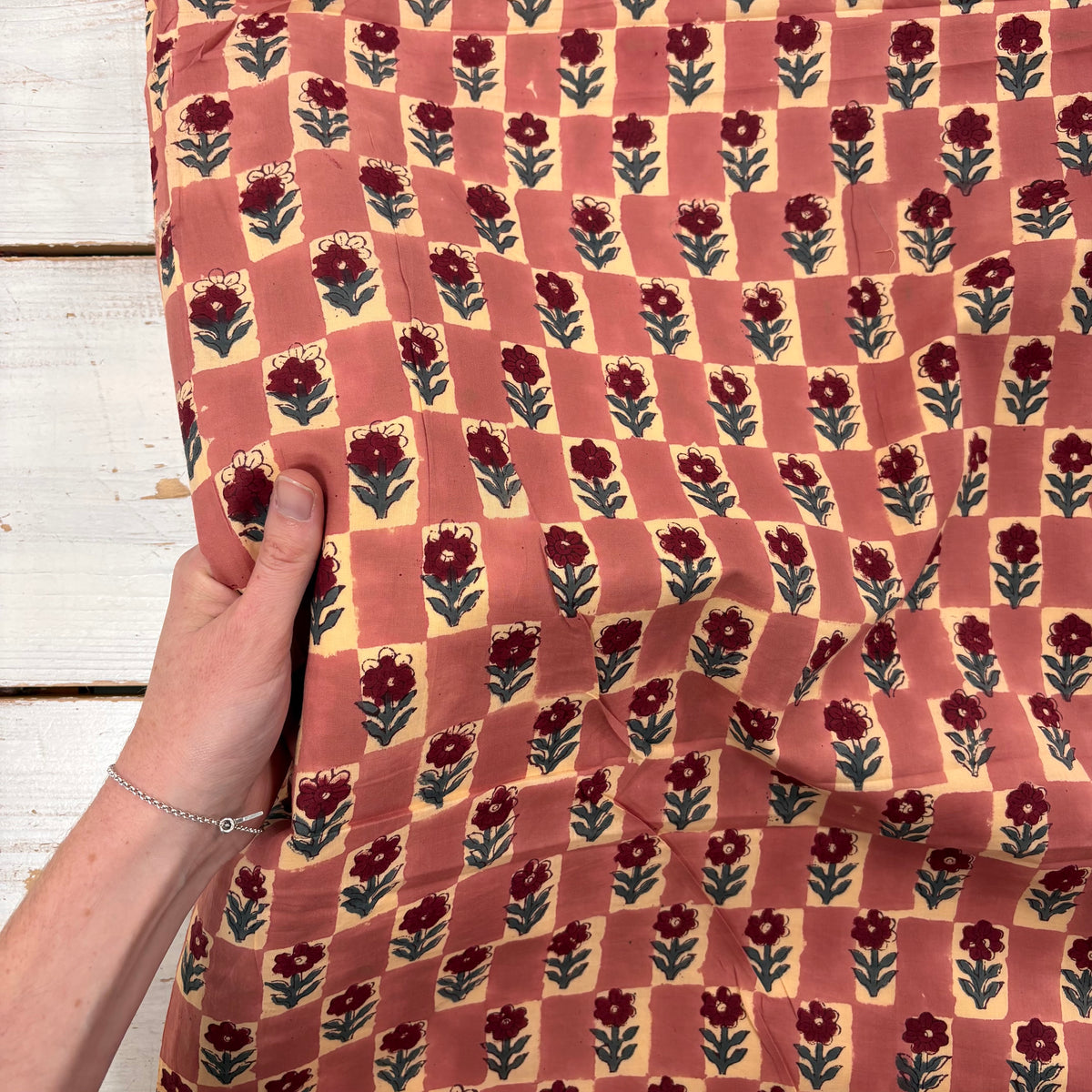 Floral Chess Block Print Cotton Fabric, with hand for scale, lightweight soft cotton with a traditional handcrafted Indian floral pattern
