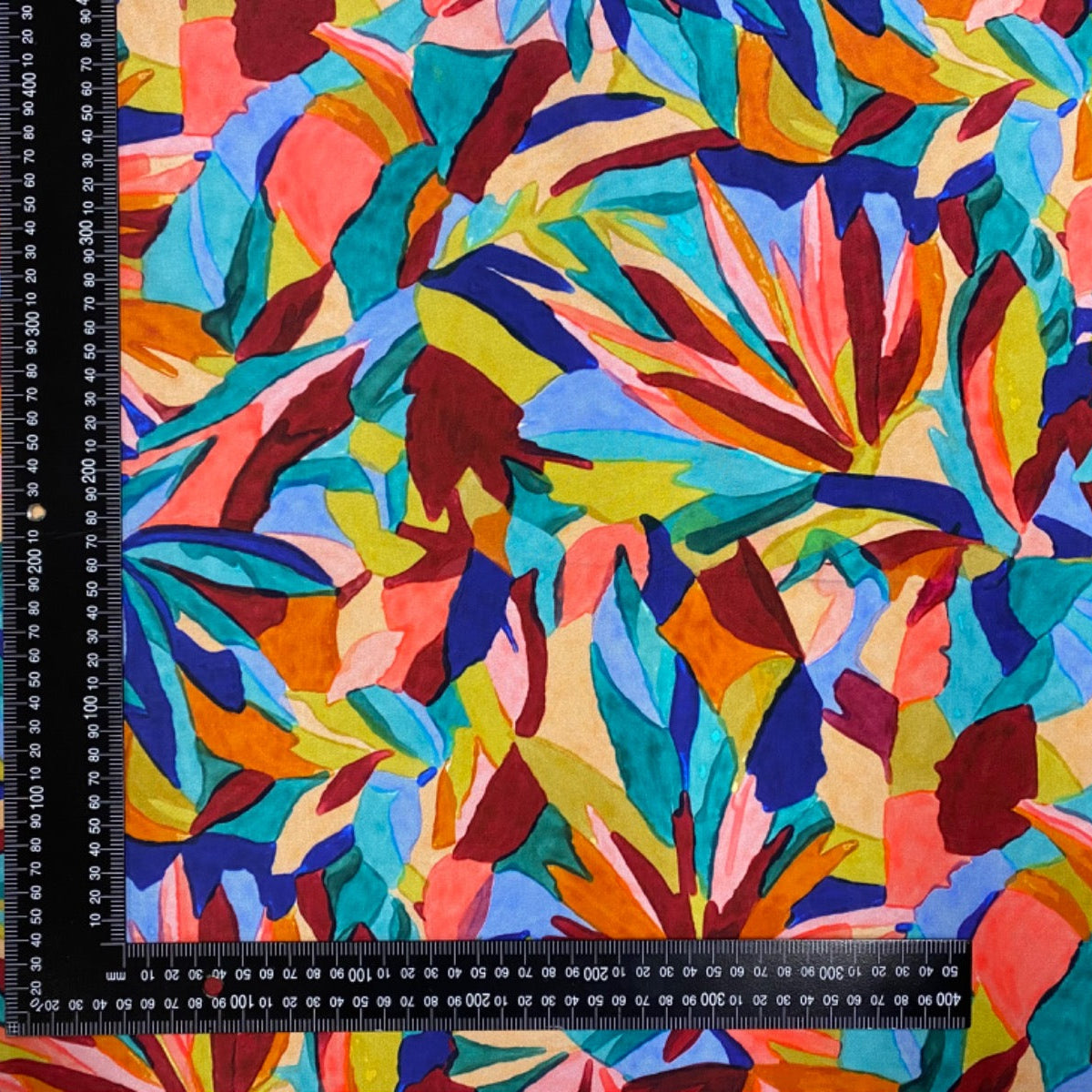 H386 Multi Leaves Rainbow Viscose dress fabric with ruler for scale