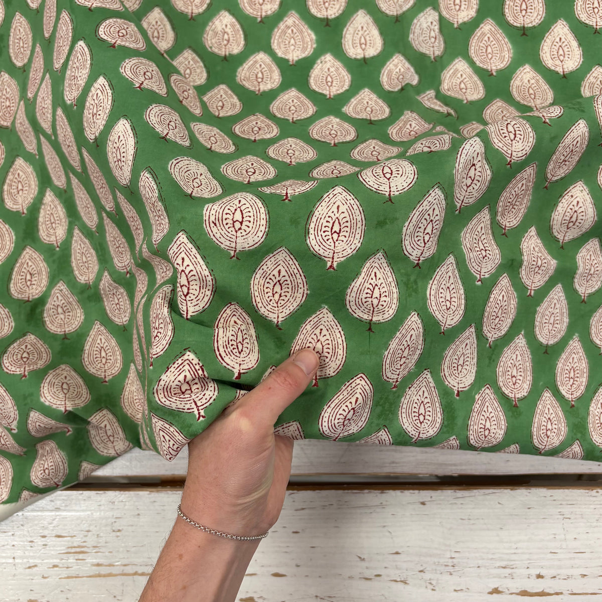 Leaf Motif Block Print Cotton Fabric, with hand for scale, lightweight soft cotton with a traditional handcrafted Indian floral pattern