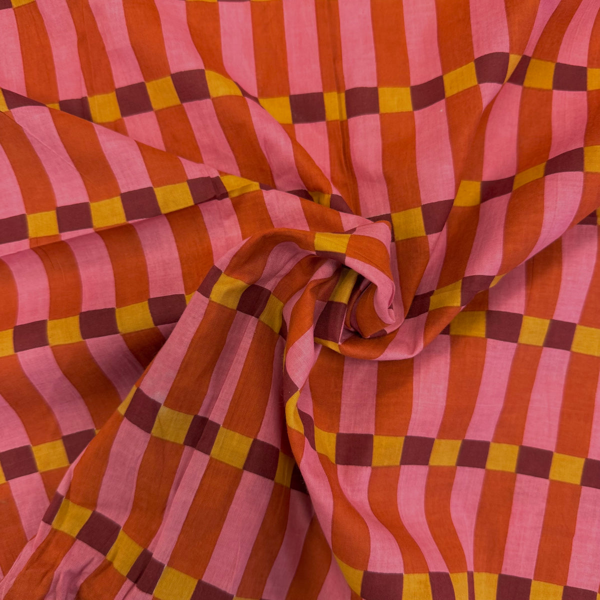 Pink Humbug Check Indian Block Print Cotton Fabric gathered, lightweight 100gsm printed cotton for dressmaking, handmade gifts, crafts and soft furnishings, handcrafted using traditional Indian printing techniques.