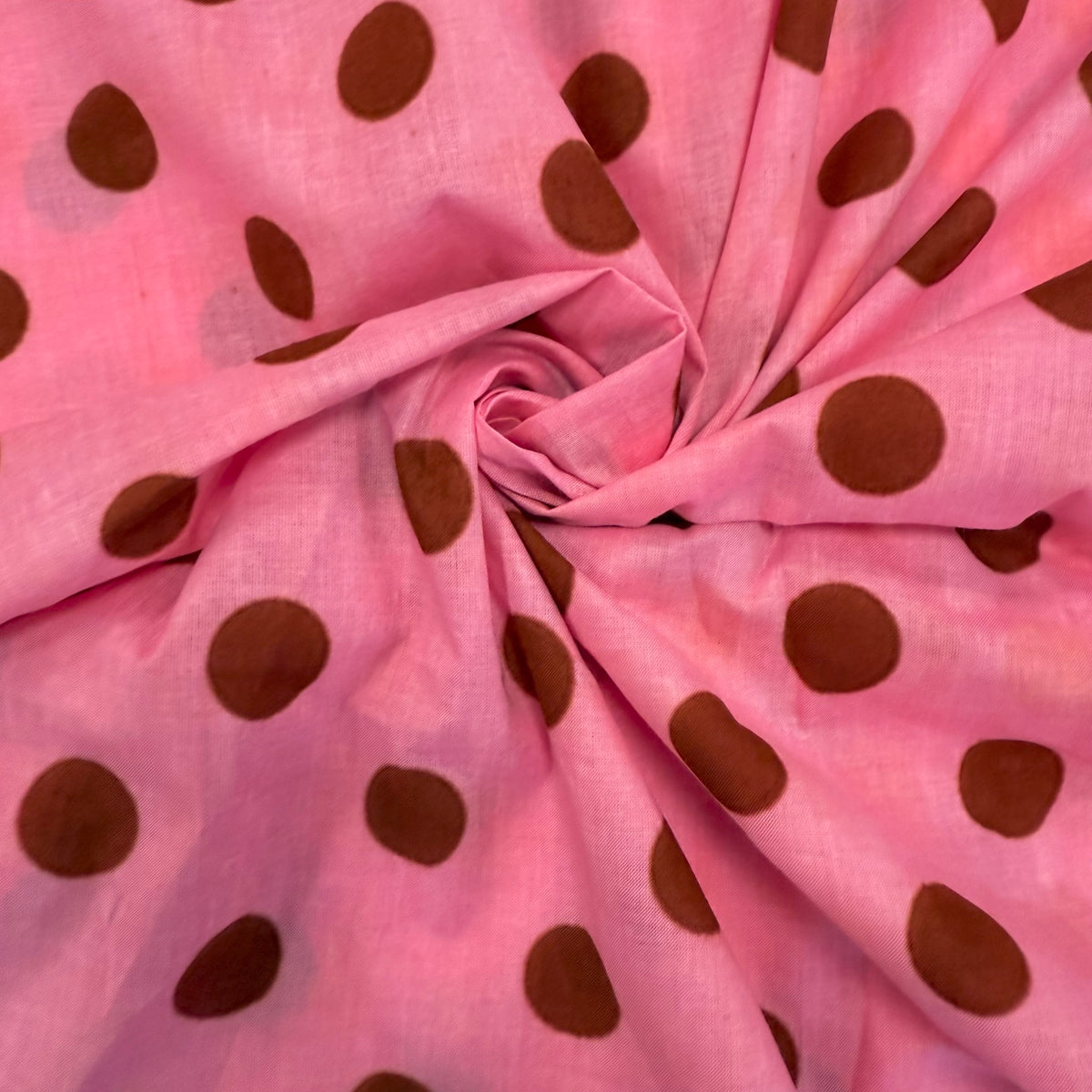 Pink Spotty Indian Print Cotton Fabric gathered, lightweight 100gsm printed cotton for dressmaking, handmade gifts, crafts and soft furnishings, handcrafted using traditional Indian printing techniques.