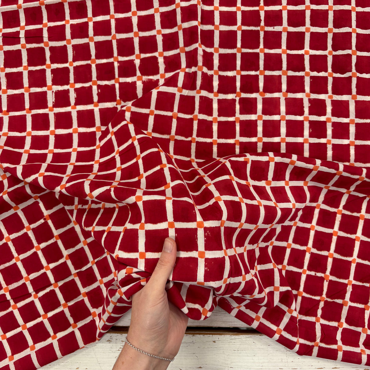 Squares Block Print Cotton Fabric, with hand for scale, lightweight soft cotton with a traditional handcrafted Indian tartan check pattern.