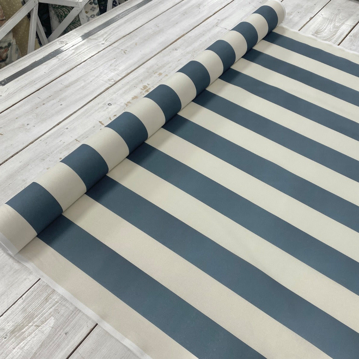 bold blue stripe fabric roll on table