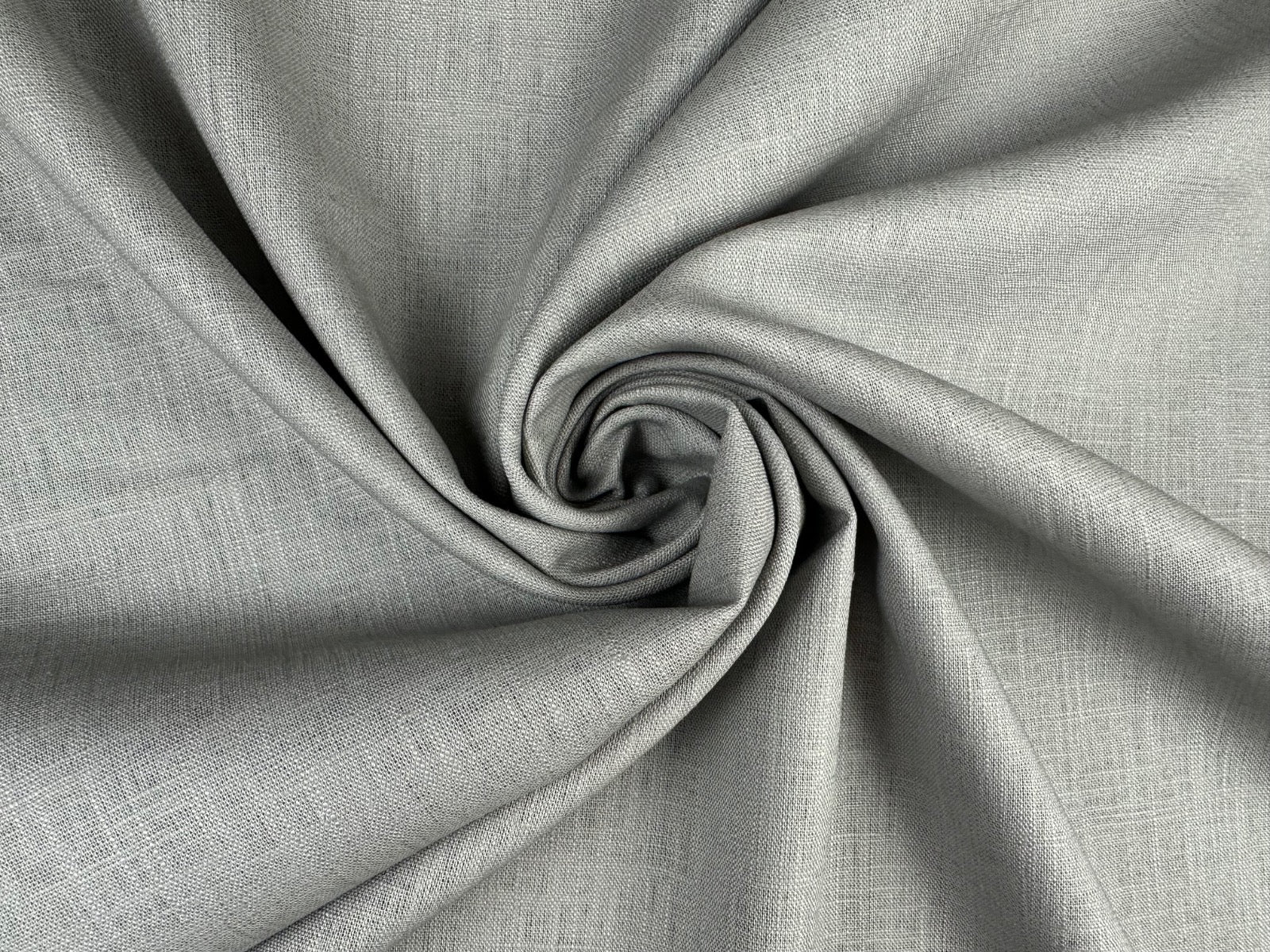 Twisted image of grey ramie linen fabric showing its natural weave and textured surface.