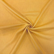 Twisted image of mustard ramie linen fabric showing its natural weave and textured surface.