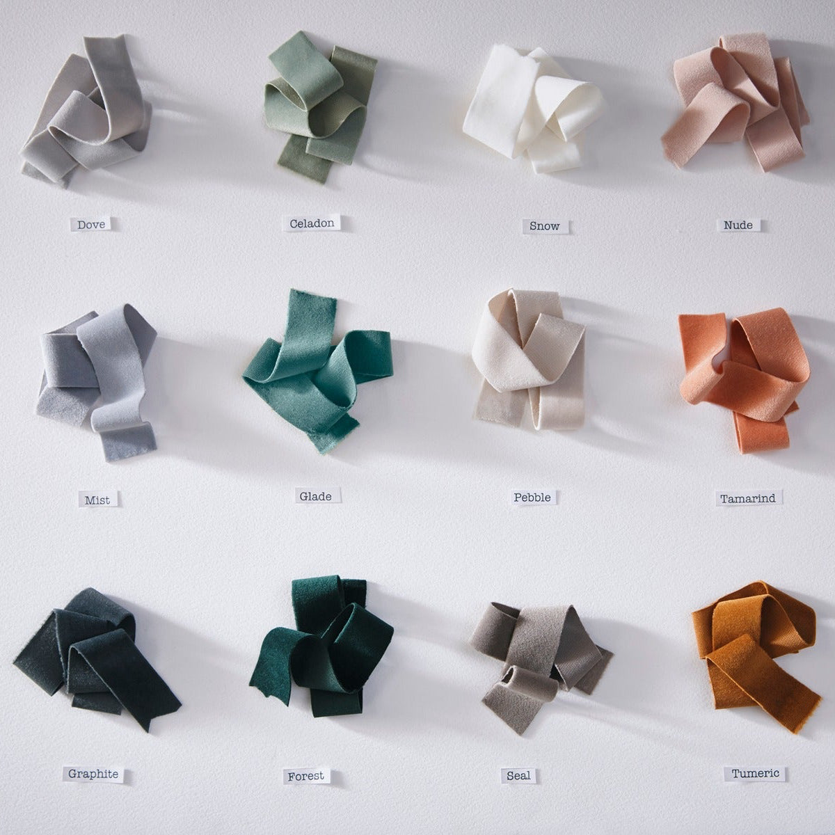 Collection of variously shaped and colored bows on a white background