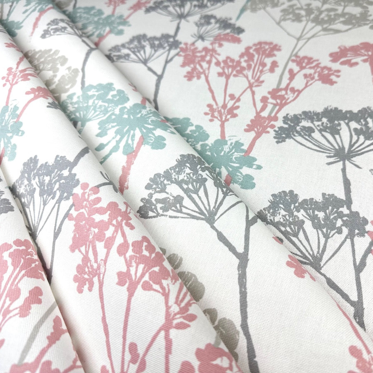 Clarke & Clarke floral cotton curtain fabric in soft pink and pastel shades.