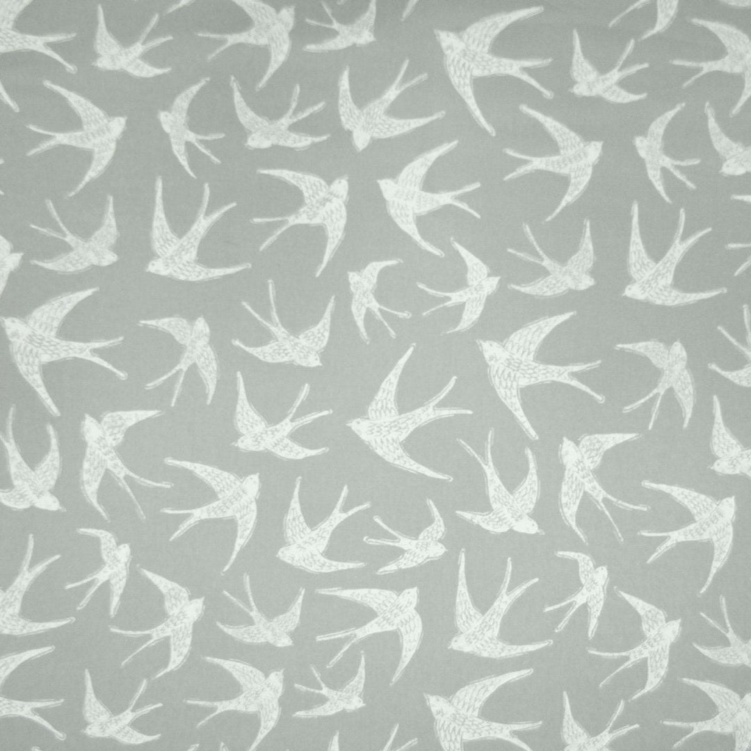 Cotton curtain fabric with coastal bird print on a grey background.