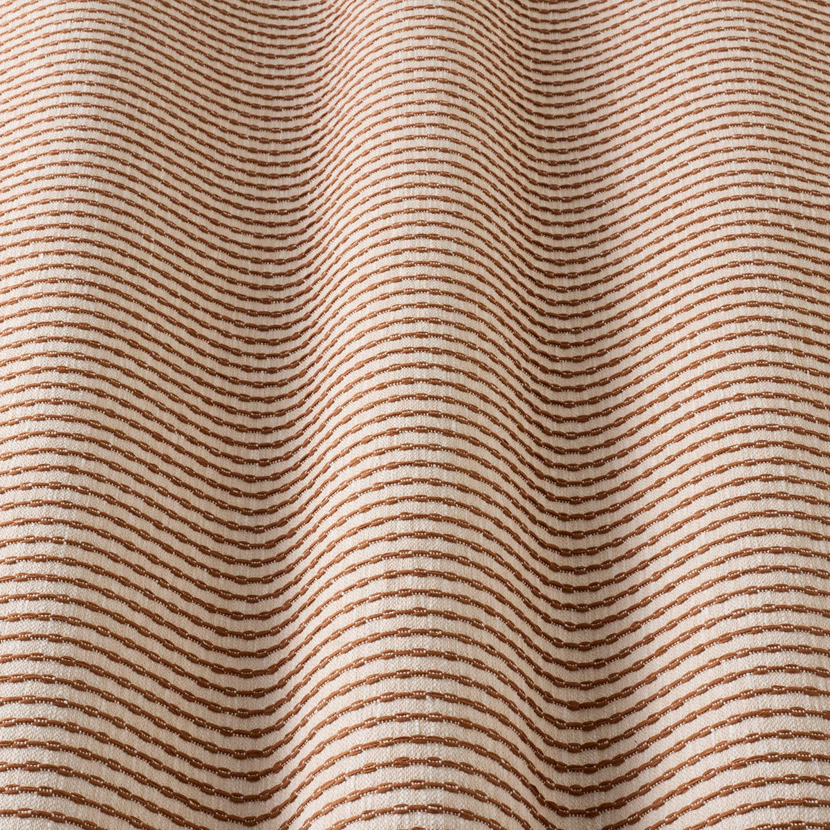 iLiv Sundara Henna fabric gathered, a contemporary woven stripe cotton-mix upholstery and soft furnishing fabric in rich ochre tones from the Zafira collection.