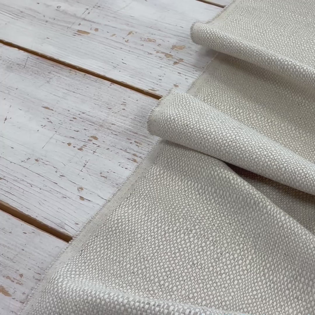Video of woven linen curtain fabric moving to show texture and weave 