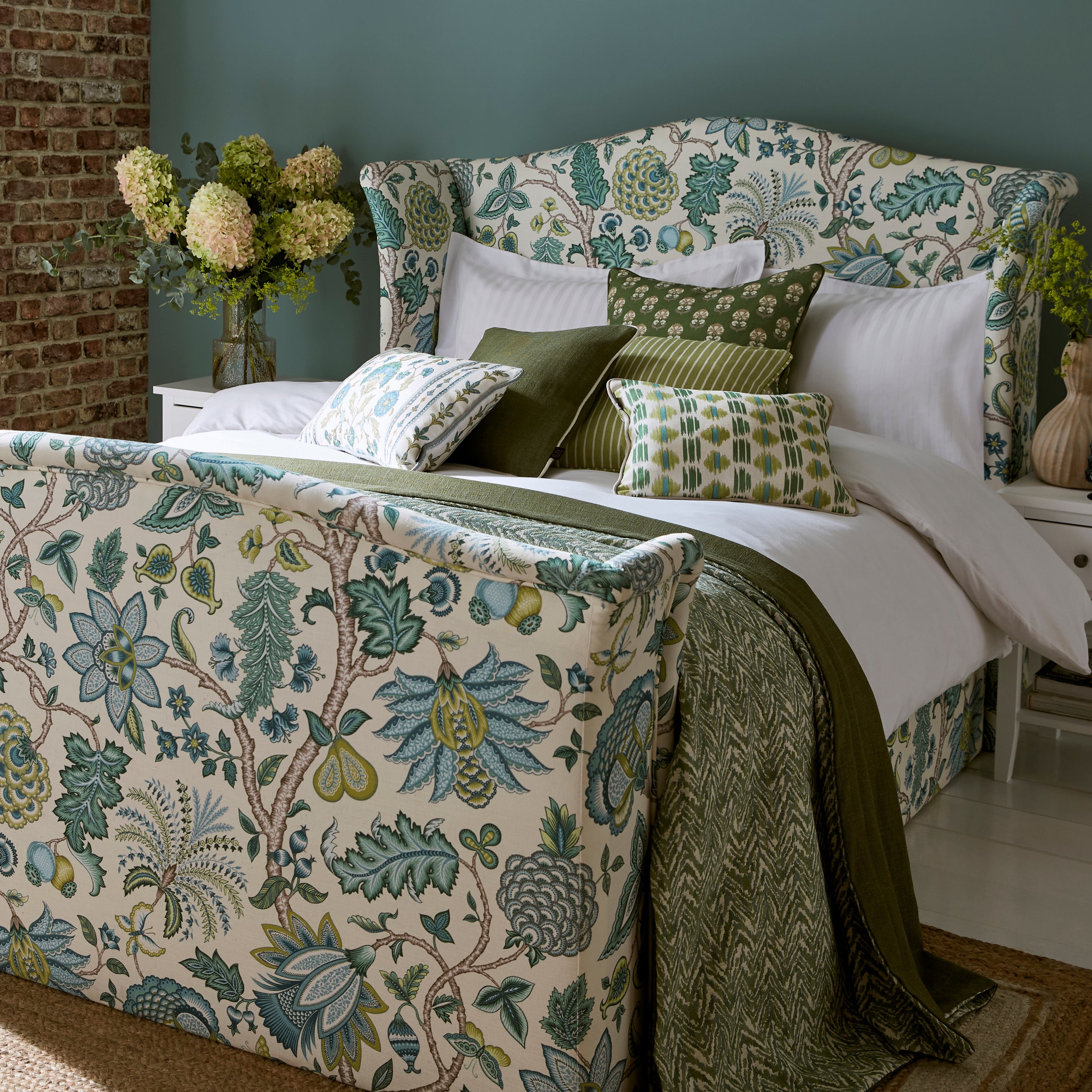 Bedroom with floral-patterned bedspread and pillows